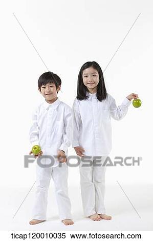 A boy and girl with green apple View Large Photo Image Stock Photography - A boy and girl with green apple . Fotosearch