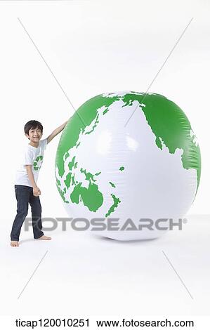 A boy in recycling shirt and a green globe View Large Photo Image Stock Image - A boy in recycling shirt and a green globe. Fotosearch