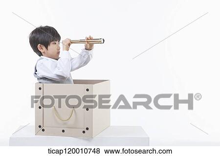 A boy looking through the telescope in the box View Large Photo Image Stock Photo - A boy looking through the telescope in the box. Fotosearch