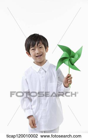 Stock Image - A boy with green pinwheel. Fotosearch
