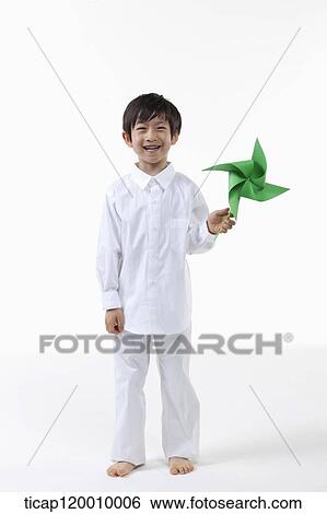 Stock Photograph - A boy with green pinwheel. Fotosearch