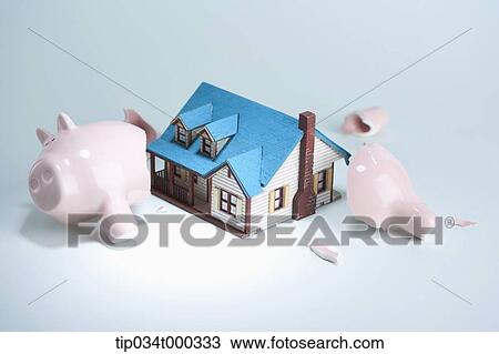 A broken piggy bank and a house View Large Photo Image Stock Image - A broken piggy bank and a house. Fotosearch