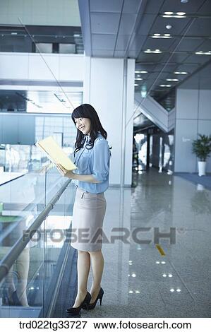 A business woman looking over the document View Large Photo Image Stock Photo - A business woman looking over the document. Fotosearch