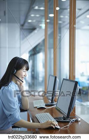 A business woman putting on the headset View Large Photo Image Stock Image - A business woman putting on the headset. Fotosearch