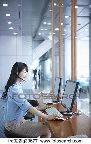 A business woman putting on the headset View Large Photo Image Stock Photo - A business woman putting on the headset. Fotosearch
