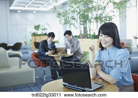 A business woman smiling with the laptop View Large Photo Image Stock Image - A business woman smiling with the laptop . Fotosearch