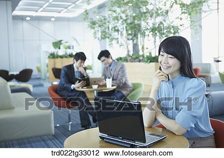 A business woman smiling with the laptop View Large Photo Image Stock Image - A business woman smiling with the laptop . Fotosearch