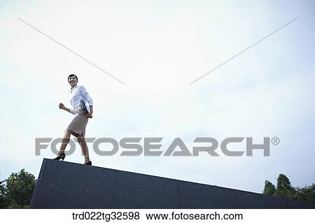 A business woman standing with the briefcase View Large Photo Image Stock Photo - A business woman standing with the briefcase. Fotosearch