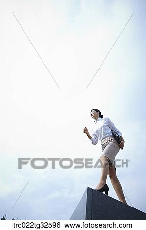 A business woman standing with the briefcase View Large Photo Image Stock Photograph - A business woman standing with the briefcase. Fotosearch