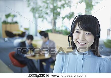 A business woman with a headphone on her head View Large Photo Image Stock Photograph - A business woman with a headphone on her head. Fotosearch
