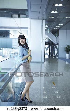 Stock Image - A business woman with the document file. Fotosearch