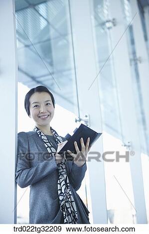 Stock Photo - A business woman with the planner. Fotosearch