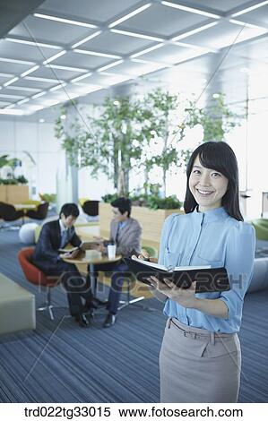 Stock Photography - A business woman writing the schedule on the planner. Fotosearch