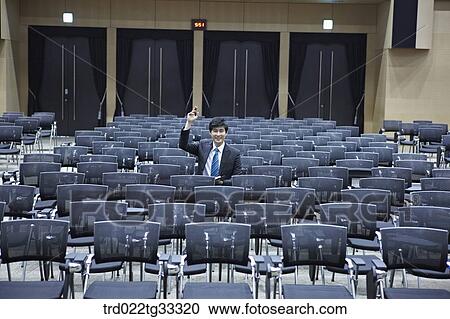 A businessman asking the question in the auditorium View Large Photo Image Stock Image - A businessman asking the question in the auditorium. Fotosearch