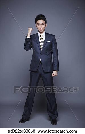 Stock Photo - A businessman clenching his fist. Fotosearch