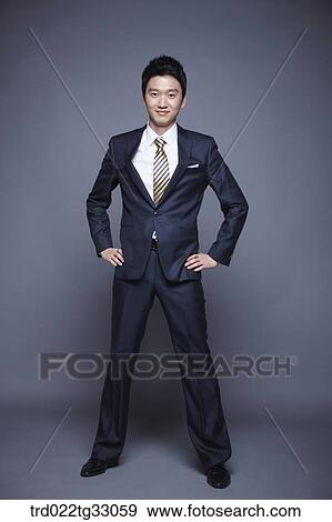 A businessman having his arms on the waist View Large Photo Image Stock Photo - A businessman having his arms on the waist. Fotosearch