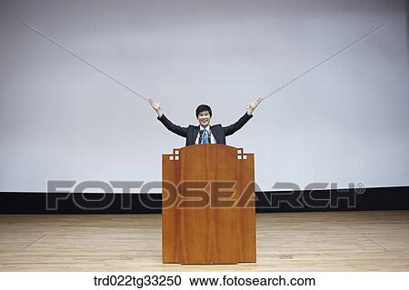 A businessman having presentation on the stage View Large Photo Image Stock Image - A businessman having presentation on the stage. Fotosearch