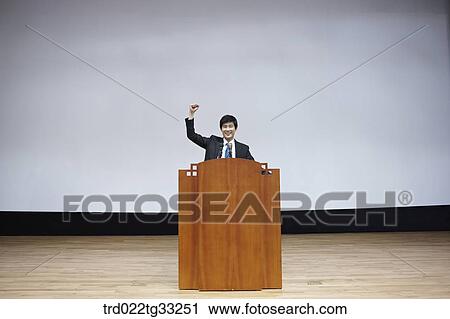 A businessman having presentation on the stage View Large Photo Image Stock Image - A businessman having presentation on the stage. Fotosearch
