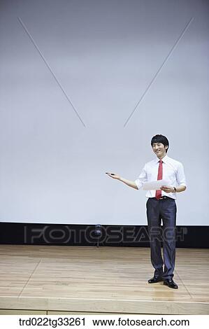 A businessman having presentation on the stage View Large Photo Image Stock Image - A businessman having presentation on the stage. Fotosearch