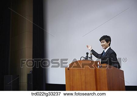 A businessman having presentation on the stage View Large Photo Image Stock Photo - A businessman having presentation on the stage. Fotosearch