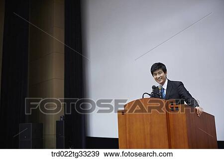 A businessman having presentation on the stage View Large Photo Image Stock Photo - A businessman having presentation on the stage. Fotosearch