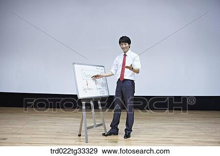 Stock Photo - A businessman having presentation with a white board. Fotosearch