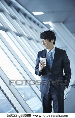 A businessman having the coffee by the window View Large Photo Image Stock Photo - A businessman having the coffee by the window. Fotosearch