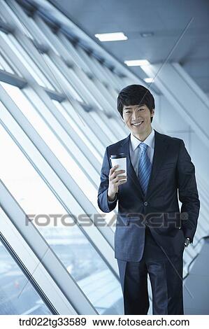 Stock Photo - A businessman having the coffee by the window. Fotosearch