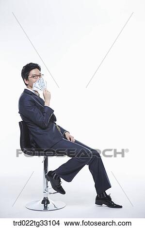 A businessman holding the money View Large Photo Image Picture - A businessman holding the money. Fotosearch