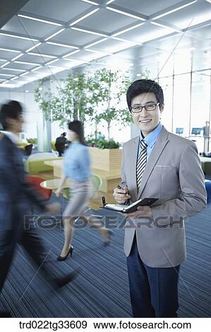 A businessman holding the planner View Large Photo Image Stock Photo - A businessman holding the planner. Fotosearch