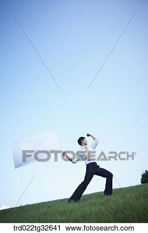 A businessman holding the white flag View Large Photo Image Stock Image - A businessman holding the white flag. Fotosearch
