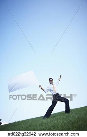 A businessman holding the white flag View Large Photo Image Stock Image - A businessman holding the white flag. Fotosearch