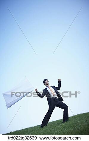 Stock Photo - A businessman holding the white flag. Fotosearch