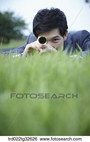 A businessman looking through the telescope View Large Photo Image Stock Photograph - A businessman looking through the telescope. Fotosearch
