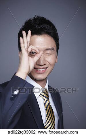 A businessman making OK sign View Large Photo Image Stock Image - A businessman making OK sign. Fotosearch