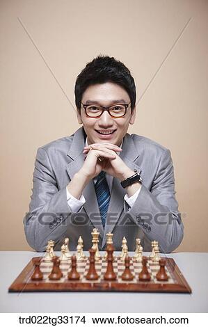 A businessman playing chess game View Large Photo Image Picture - A businessman playing chess game. Fotosearch