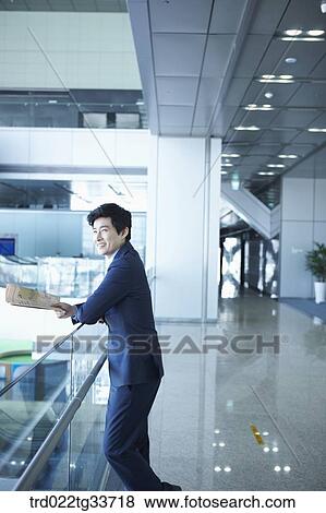 Stock Photo - A businessman reading the newspaper. Fotosearch