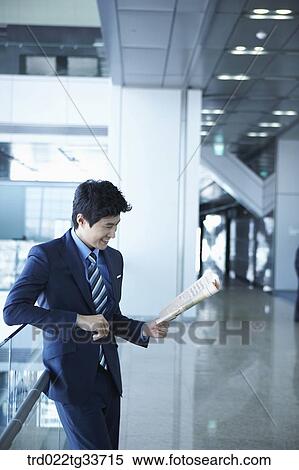 A businessman reading the newspaper View Large Photo Image Stock Photography - A businessman reading the newspaper. Fotosearch