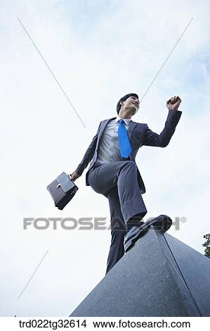 A businessman running with the briefcase View Large Photo Image Picture - A businessman running with the briefcase. Fotosearch