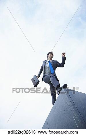 A businessman running with the briefcase View Large Photo Image Stock Image - A businessman running with the briefcase. Fotosearch