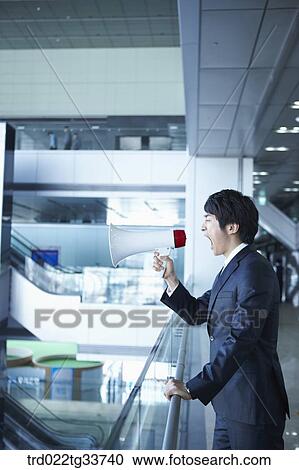 A businessman shouting to the loudspeaker View Large Photo Image Stock Image - A businessman shouting to the loudspeaker. Fotosearch