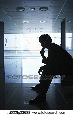 A businessman sitting in the hallway View Large Photo Image Stock Photo - A businessman sitting in the hallway. Fotosearch