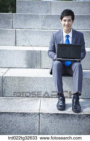 A businessman sitting with the laptop View Large Photo Image Stock Image - A businessman sitting with the laptop. Fotosearch