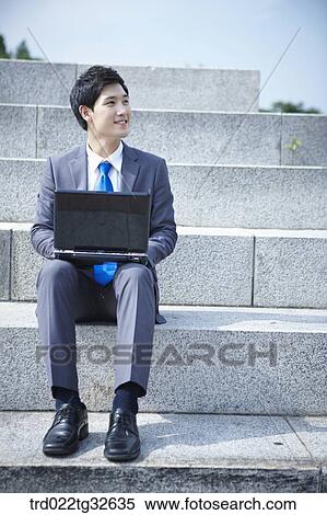 A businessman sitting with the laptop View Large Photo Image Stock Photography - A businessman sitting with the laptop. Fotosearch