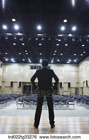 A businessman standing on the stage View Large Photo Image Stock Photograph - A businessman standing on the stage. Fotosearch