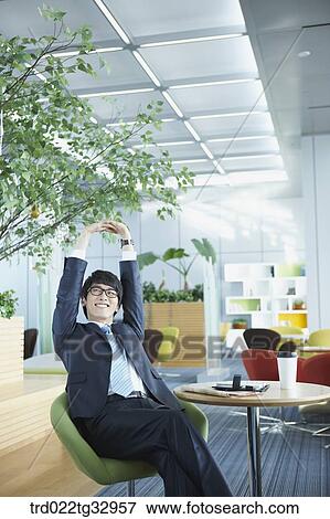 A businessman taking a break in the lounge View Large Photo Image Stock Photo - A businessman taking a break in the lounge. Fotosearch