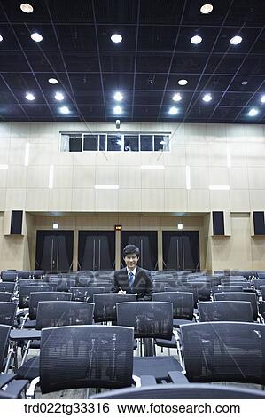 A businessman taking a note in the auditorium View Large Photo Image Stock Photograph - A businessman taking a note in the auditorium. Fotosearch