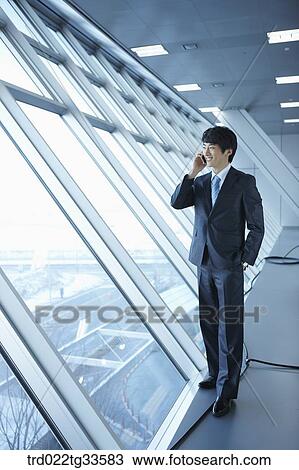 A businessman talking on the mobile View Large Photo Image Stock Image - A businessman talking on the mobile . Fotosearch