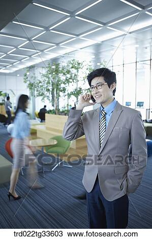 A businessman talking on the mobile View Large Photo Image Stock Image - A businessman talking on the mobile. Fotosearch