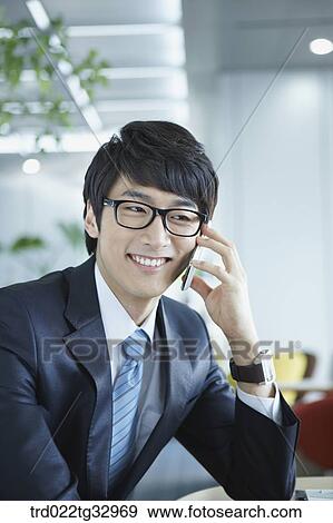 Stock Photo - A businessman talking on the mobile phone. Fotosearch